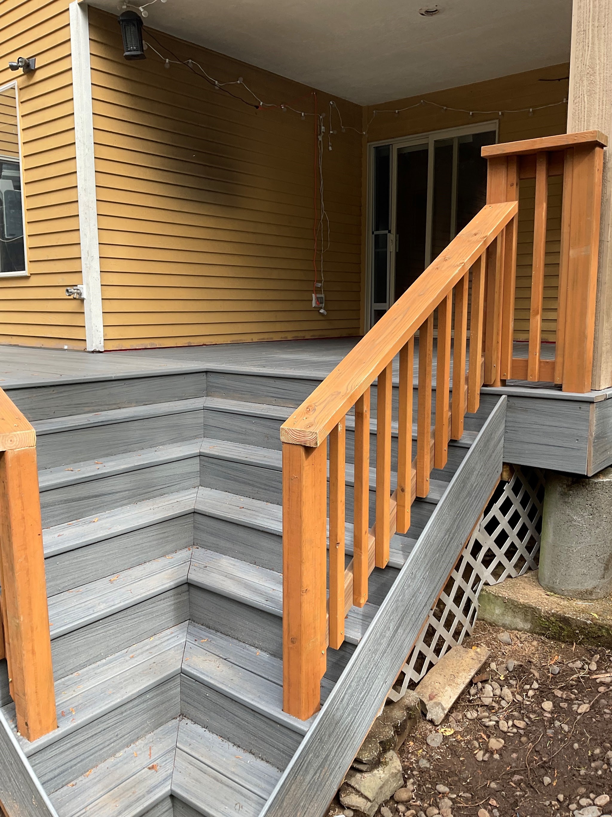 Finished deck stairs with a stained wood handrail