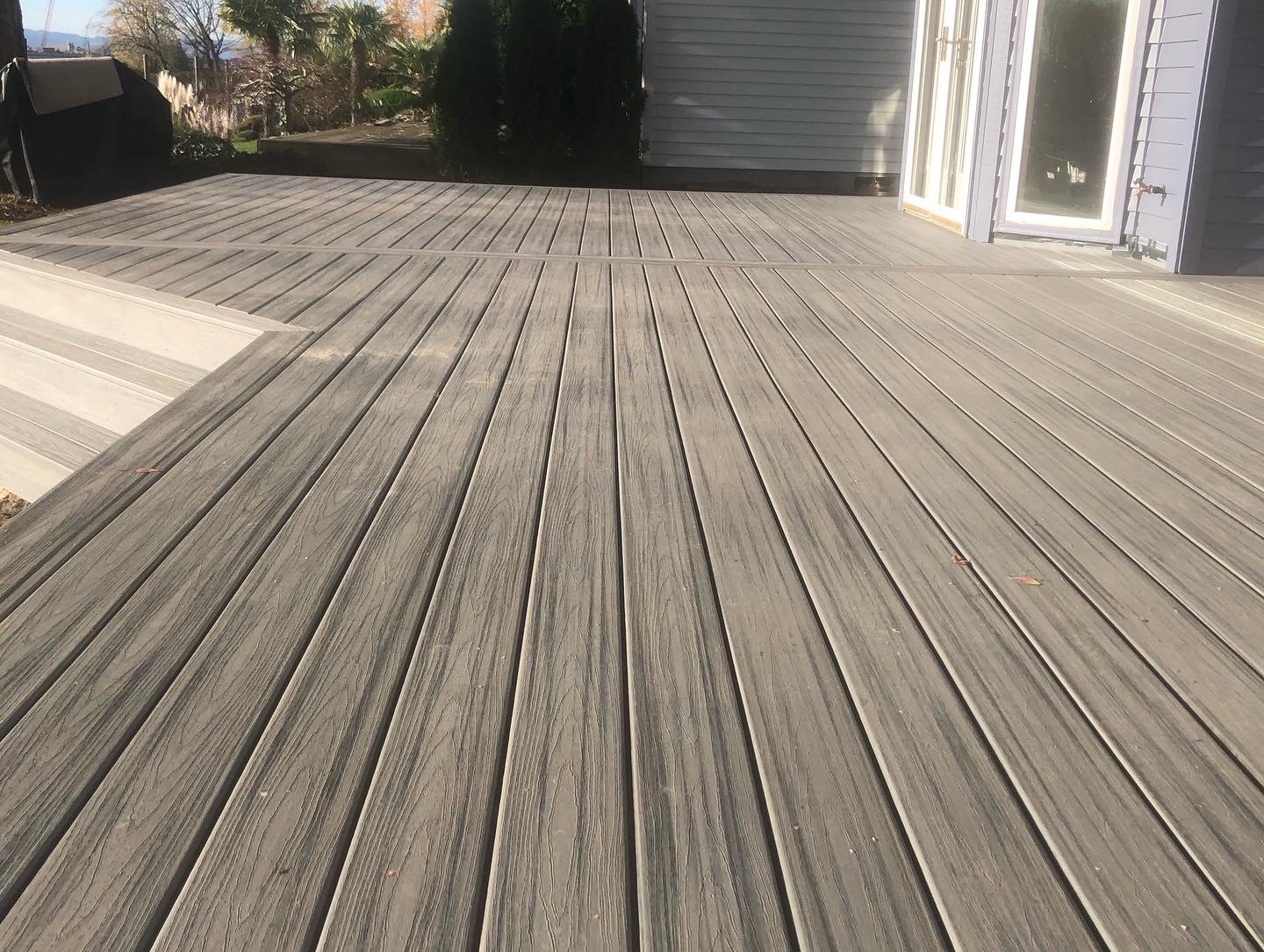 A long finished composite deck running along a home